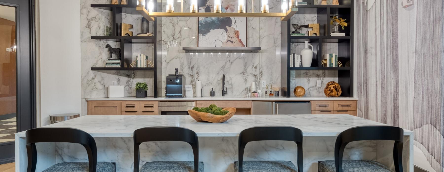a kitchen with a bar and chairs