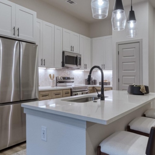 a kitchen with white cabinets