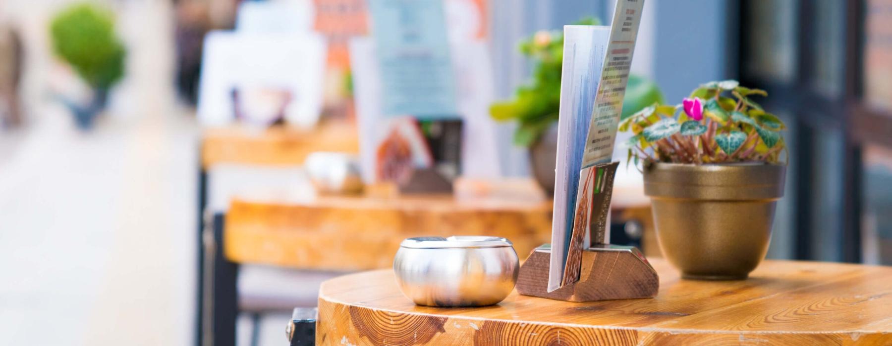 a table with bowls and plants on it