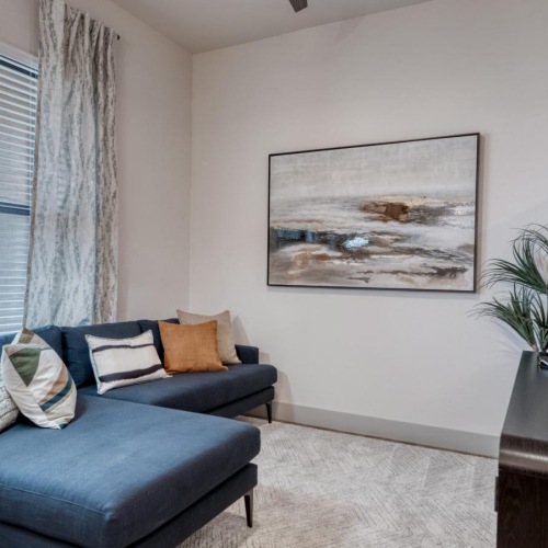 a living room with a blue couch and a coffee table